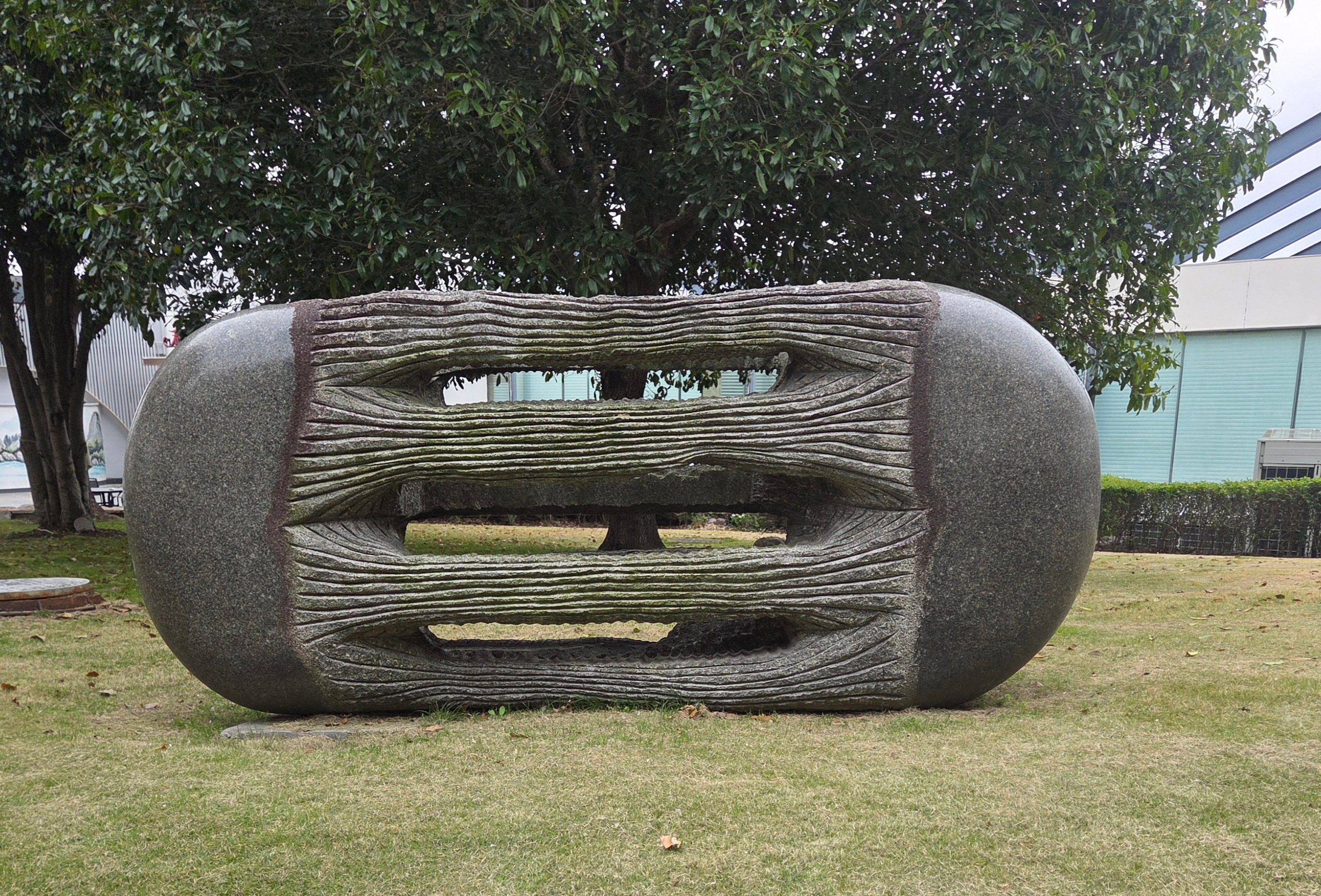 Large stone sculpture in landscaped garden